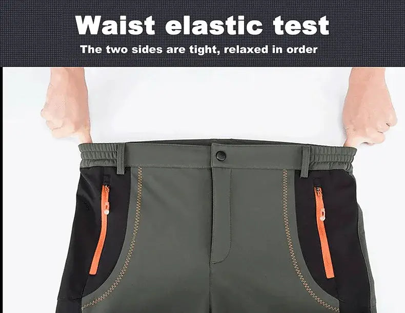 JNLN men's hiking pants in olive green with black side panels and orange zip pockets; elastic waistband.
