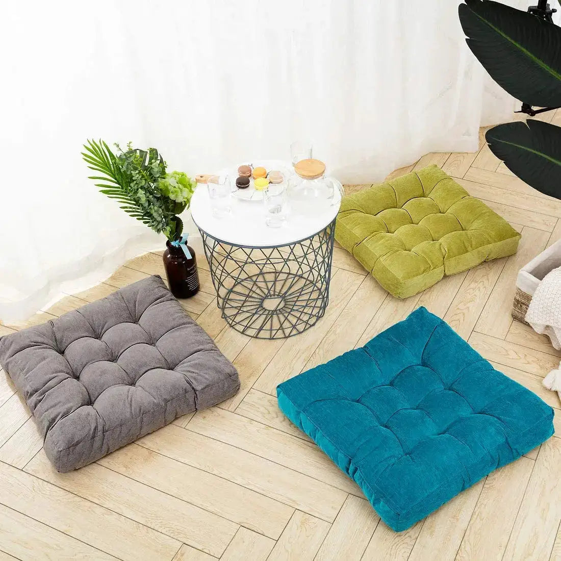 Set of 3 square floor cushions, tufted and thick, in gray, teal, and olive green for meditation and floor seating.
