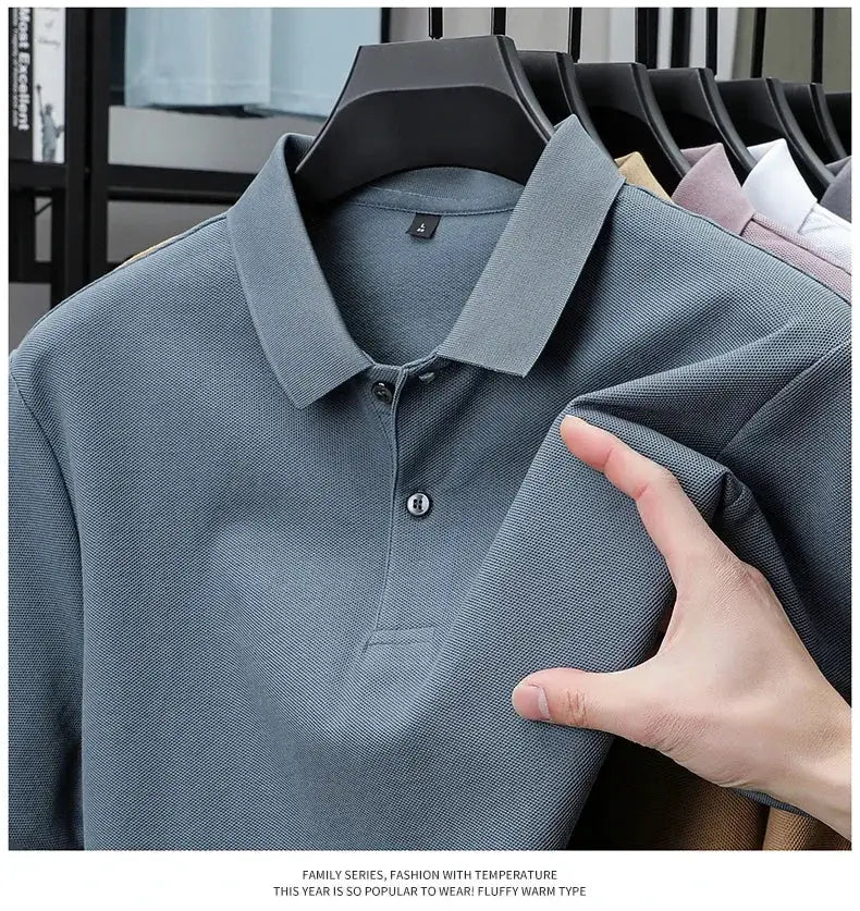 Men's 100% cotton polo shirt in blue-gray with ribbed collar and button placket on display.
