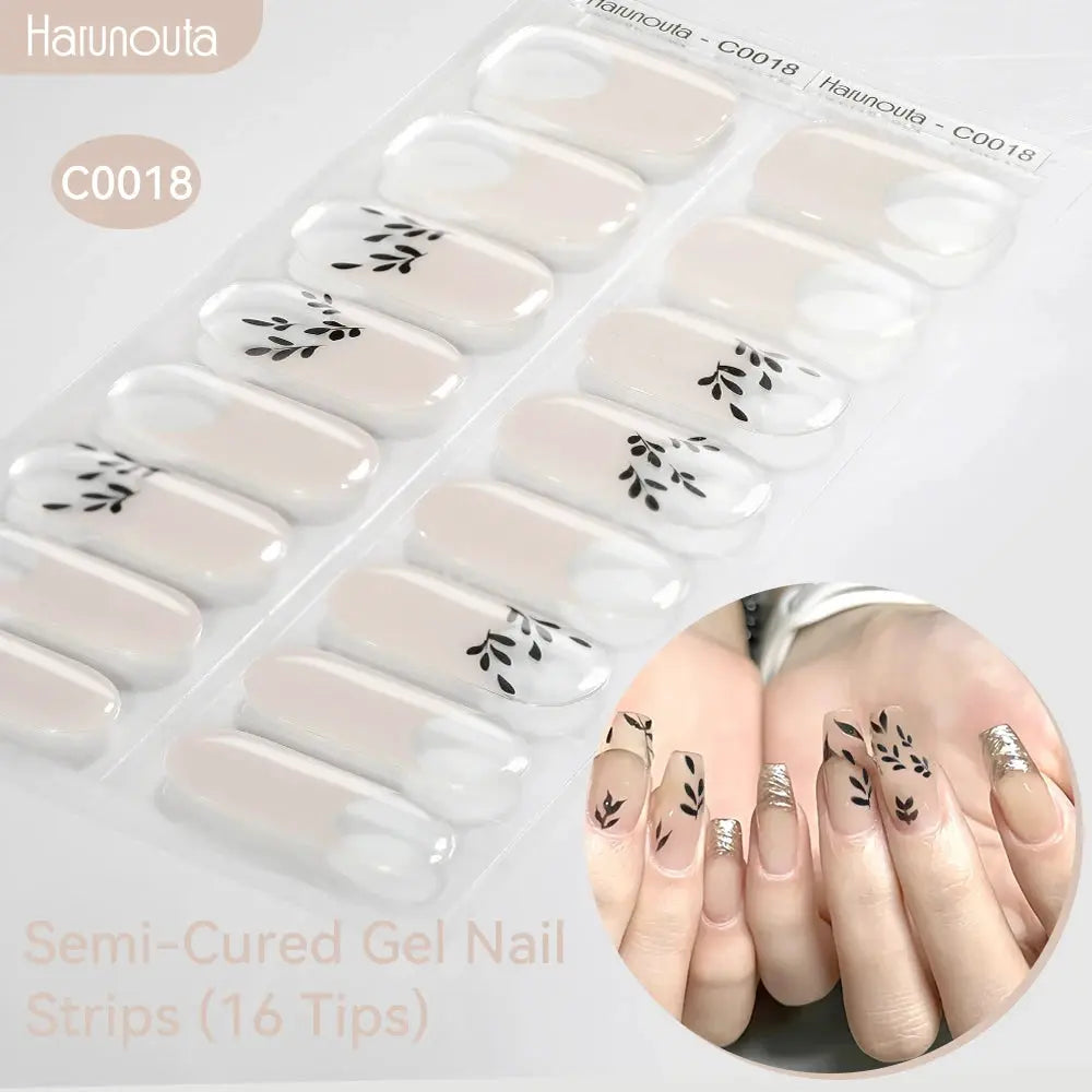 Gradient Auroras semi-cured gel nail strip set by Haunouta with beige nude bases and black leaf accents (16 tips)