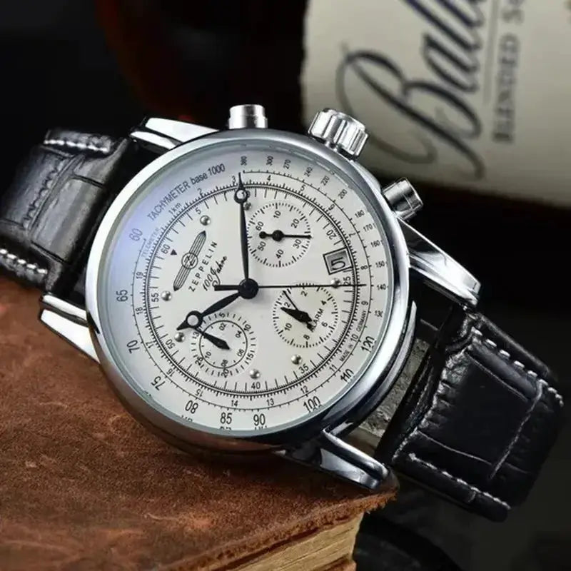 Zeppelin commemorative men's automatic watch with white dial, tachymeter, and black leather strap.