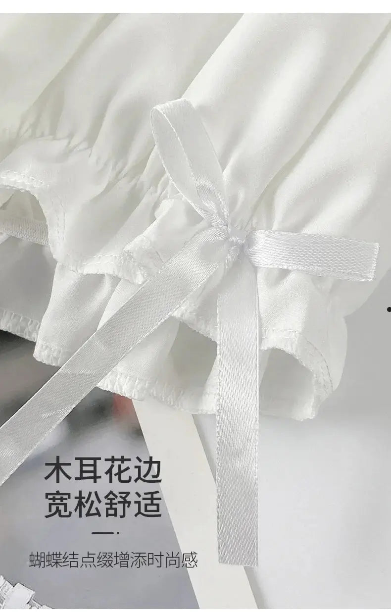 White satin shorts with an elegant bow ribbon and delicate ruffle edge, showcasing classic lingerie bloomers