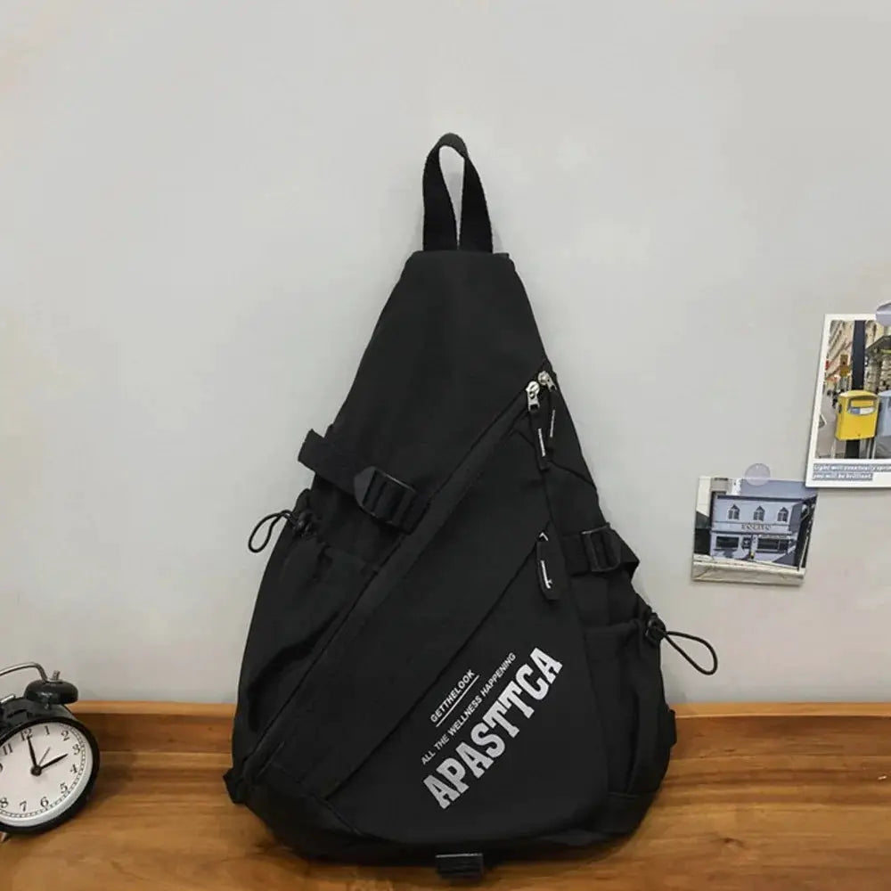 Nylon crossbody bag by Simples Market, black lightweight Y2K-style travel rucksack with multiple zip pockets.
