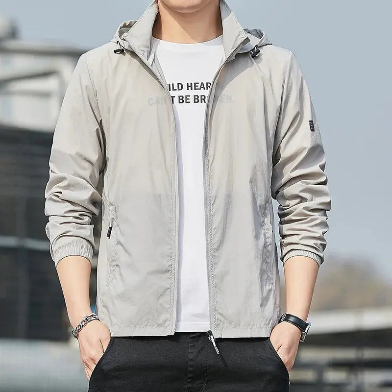 Light gray hooded windbreaker jacket with front zipper and zip pockets.