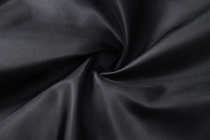 Fabric close-up: black satin with smooth folds