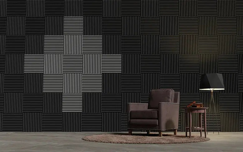 TOUO sound-absorbing foam panels on a wall in a studio, with a brown armchair and side table.