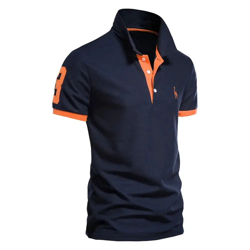 Men's navy polo shirt, short-sleeve, with orange placket and collar trim, orange cuffs, and small logo