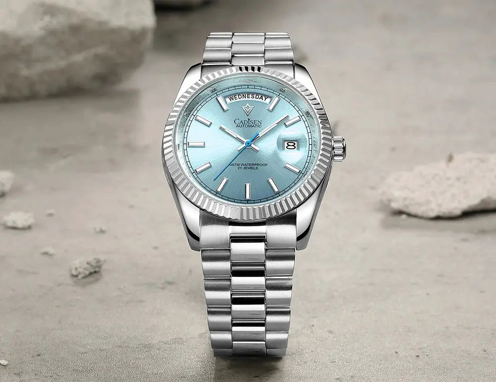 CADISEN DD40 men's stainless steel automatic watch with sky-blue dial, day window, date display, fluted bezel, and metal bracelet