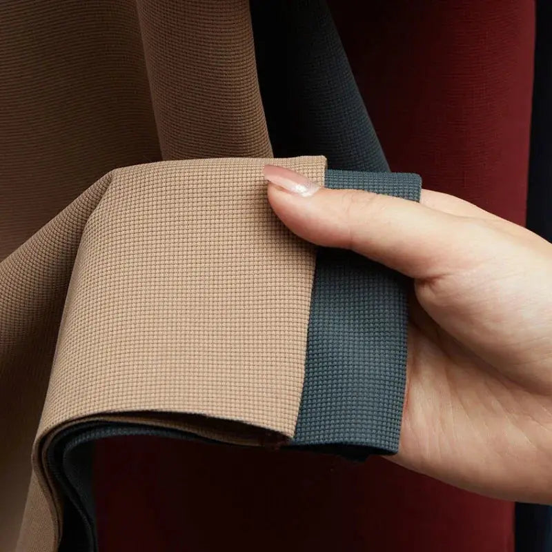 Fabric swatches for men's polo shirt in beige and blue with textured weave held in hand