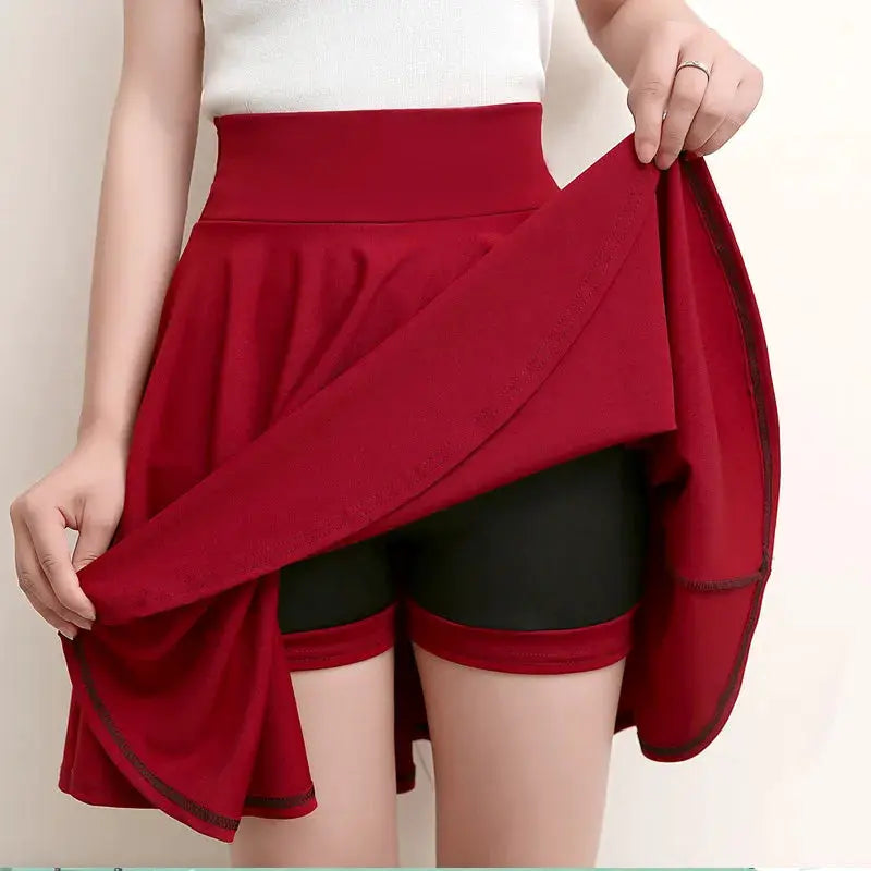 Flared skirt with red outer layer over black shorts, high-waisted casual skater style