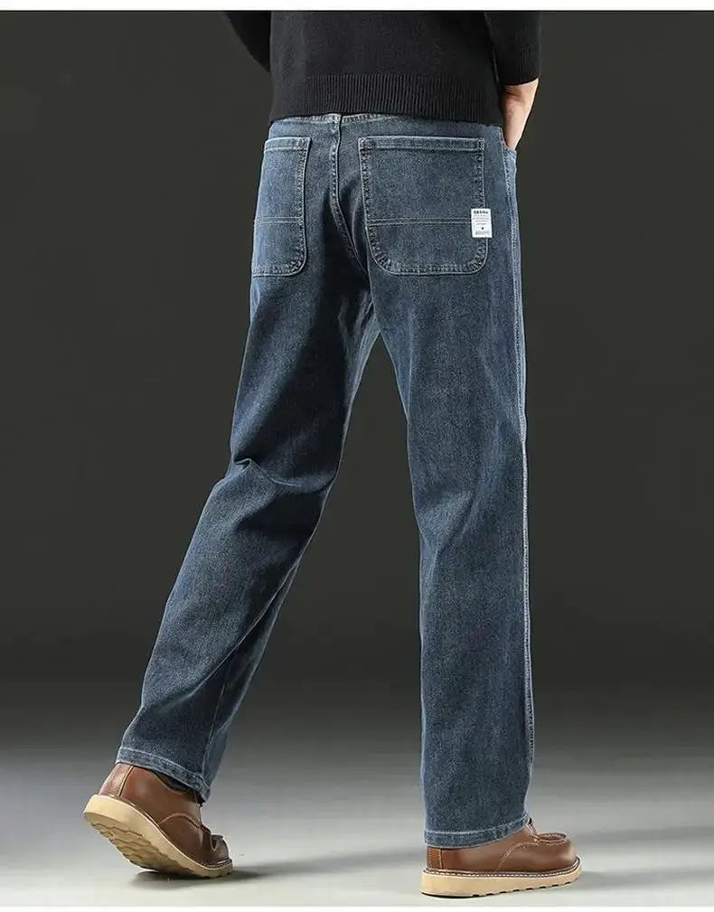 Men's baggy blue denim jeans with back pockets and a wide straight leg, casual loose fit.