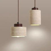 Led pendant lamps: two yellow cave-stone cylinders with brown caps and cords, warm ambient lighting.