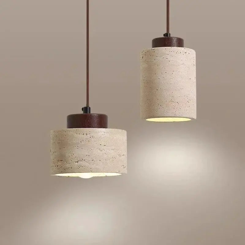 Led pendant lamps: two yellow cave-stone cylinders with brown caps and cords, warm ambient lighting.