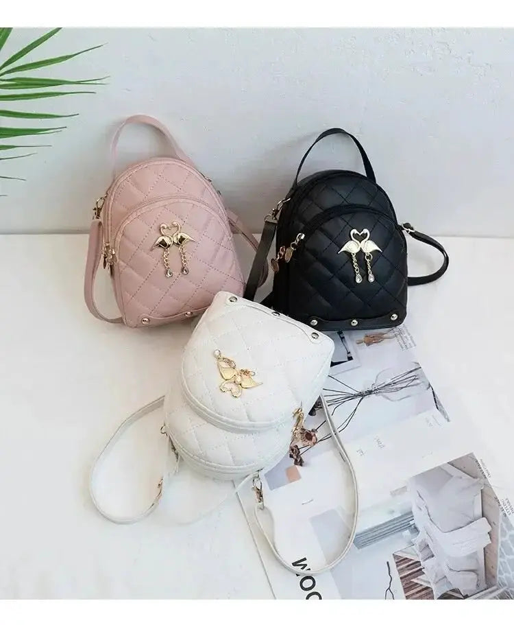 Fashion women's mini backpacks, set of 3 quilted bags in pink, white and black with gold bird charms.