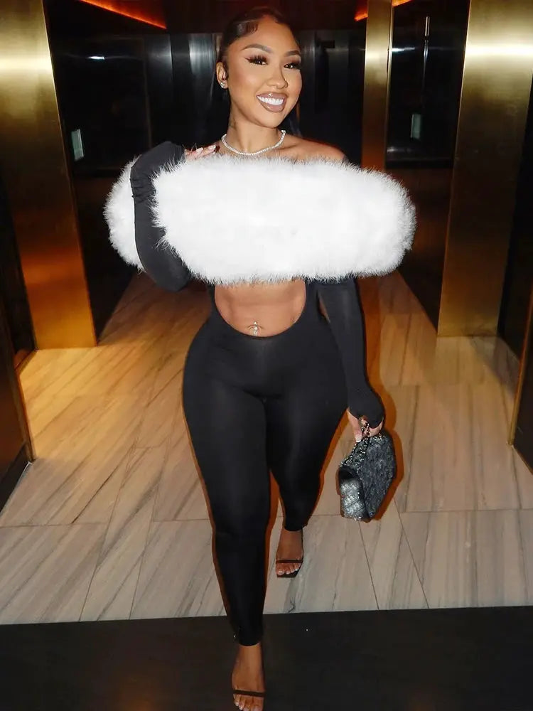Sisterlinda black furry slash-neck jumpsuit with white fluffy stole and glitter clutch