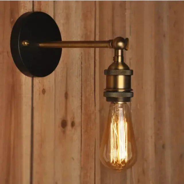 American single-head wall lamp with brass finish and exposed Edison bulb.