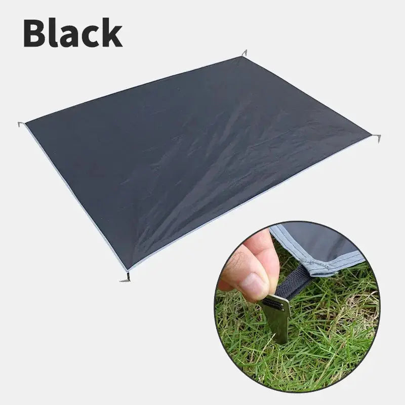 Waterproof camping mat in black with pegs; ultralight and large portable travel beach mat.