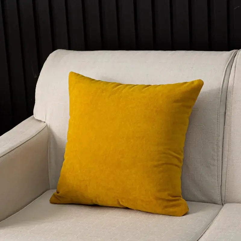 Cushion in yellow velvet on a light beige sofa, 45x45cm home decor accent.