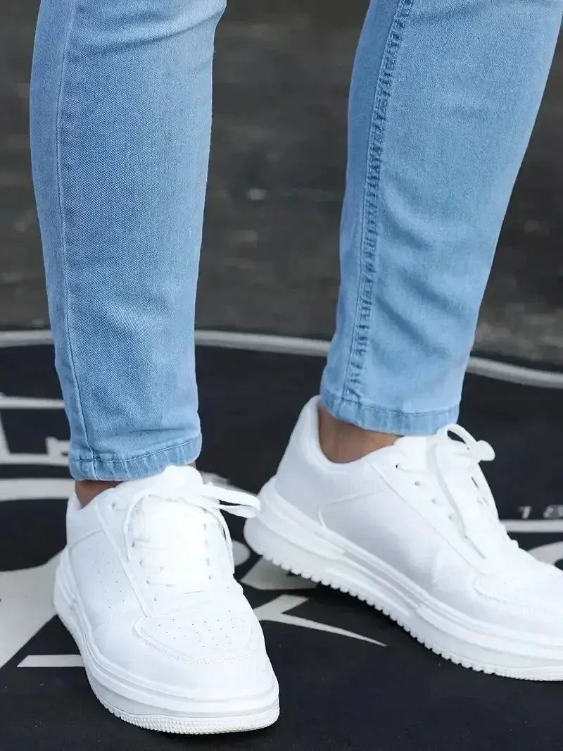Men's slim-fit blue denim jeans with white sneakers, casual street style