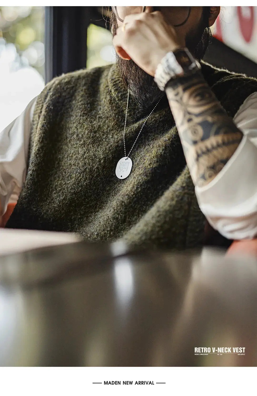 Maden retro wool-blend knitted V-neck vest for men in olive, layered over white shirt; silver dog tag necklace