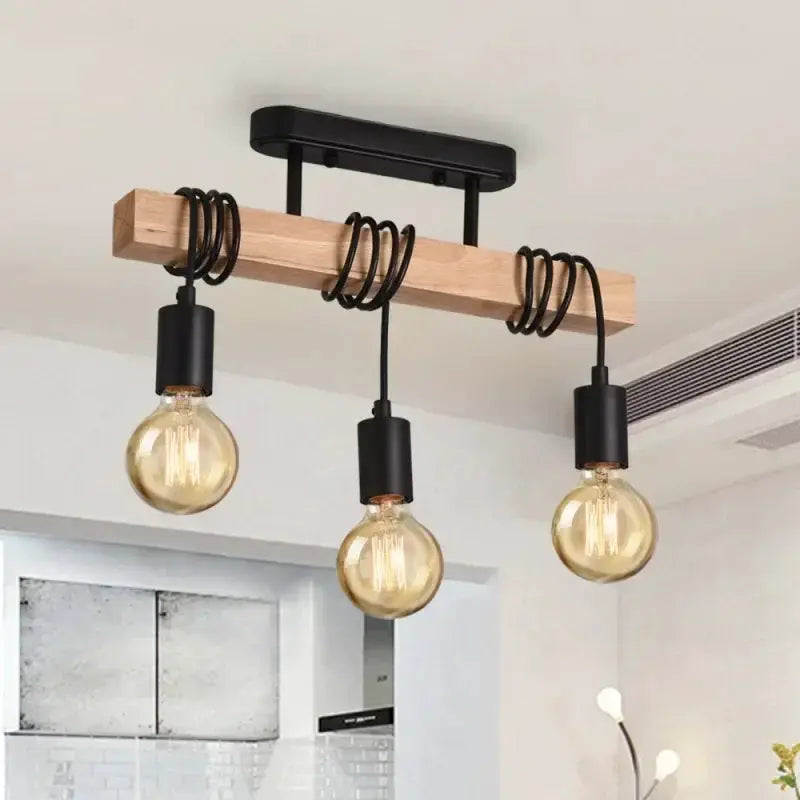 Retro wooden beam chandelier with three hanging bulbs, black sockets and spiraled cords.
