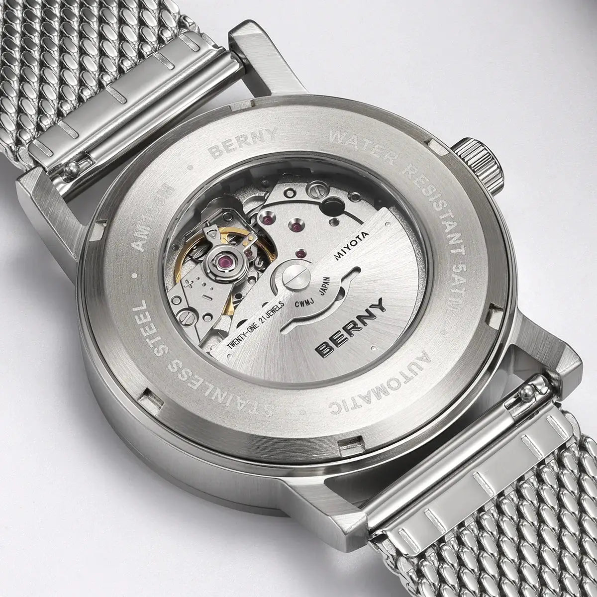 BERNY automatic men's wristwatch with stainless steel mesh band and exhibition back showing Miyota movement.