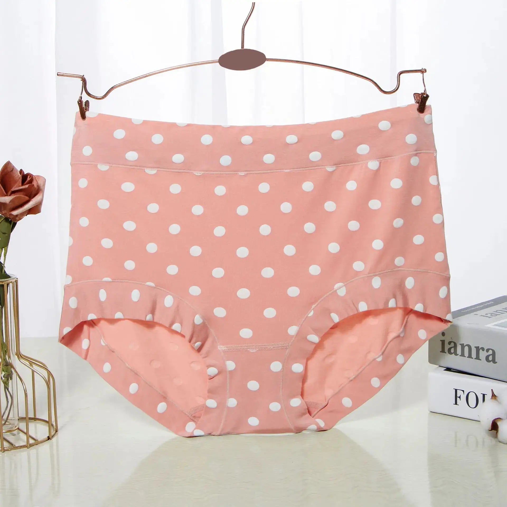 Panties by Simples Market; pink modal high-waist polka-dot briefs on a copper hanger