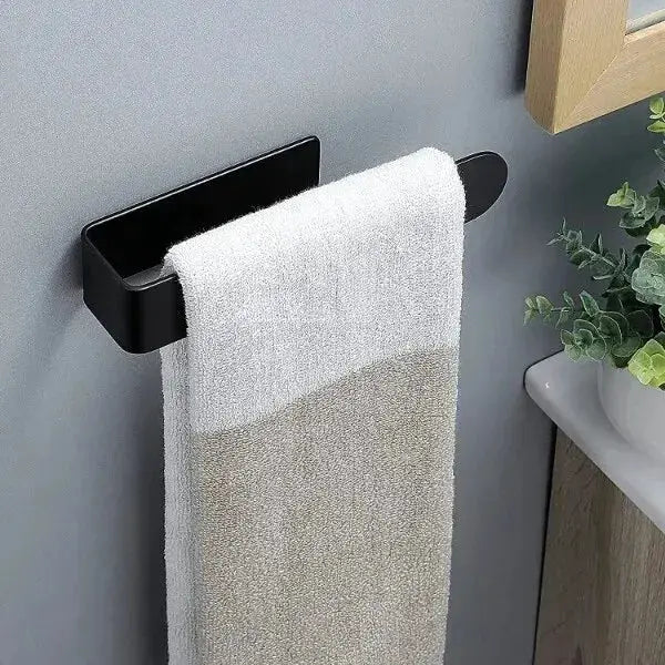 Self-adhesive towel rack, black wall-mounted holder with a white-beige towel.