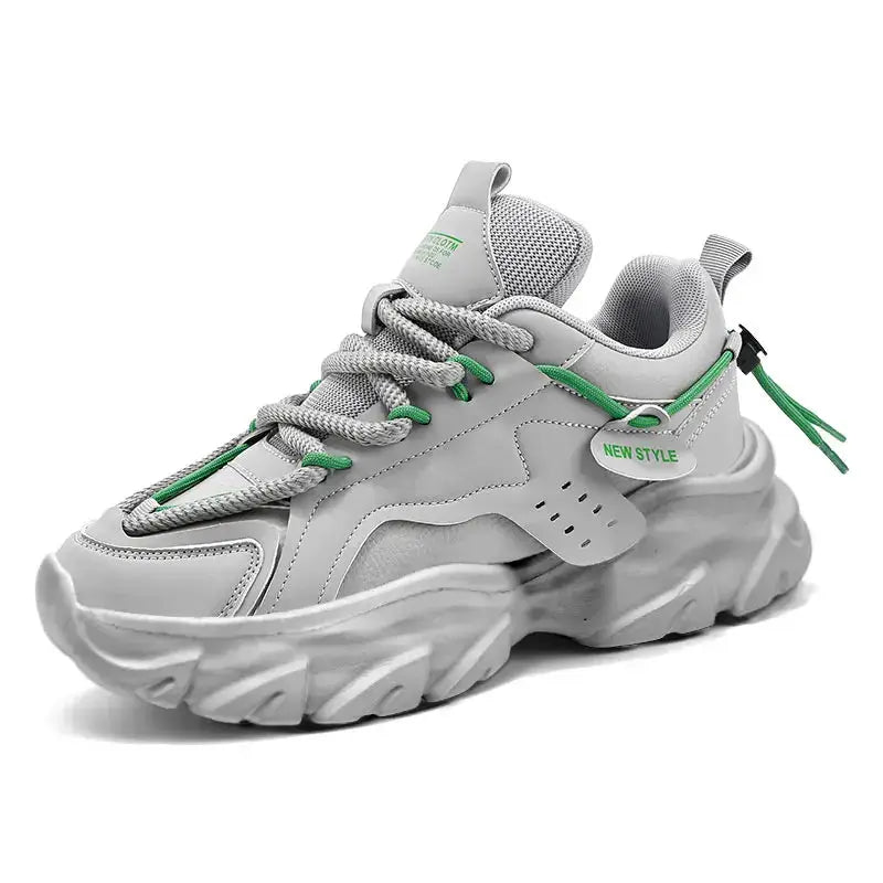 Men's sneakers with thick gray sole, breathable upper, and green laces