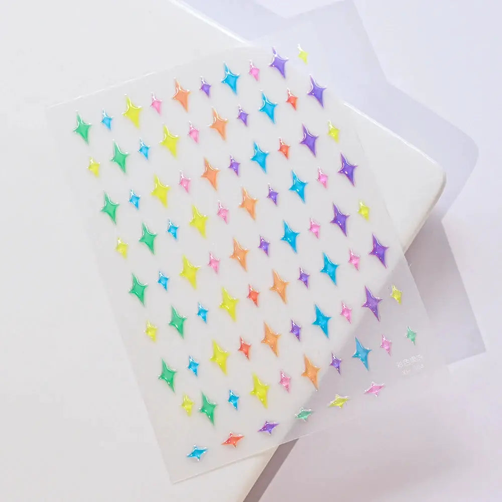 Nail decals sheet by Simples Market with dozens of rainbow iridescent diamond/star stickers for manicure
