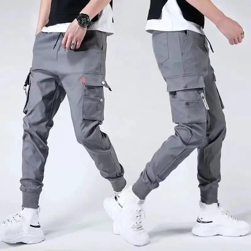 Men's gray tactical cargo pants with multiple pockets and jogger cuffs; two pairs shown