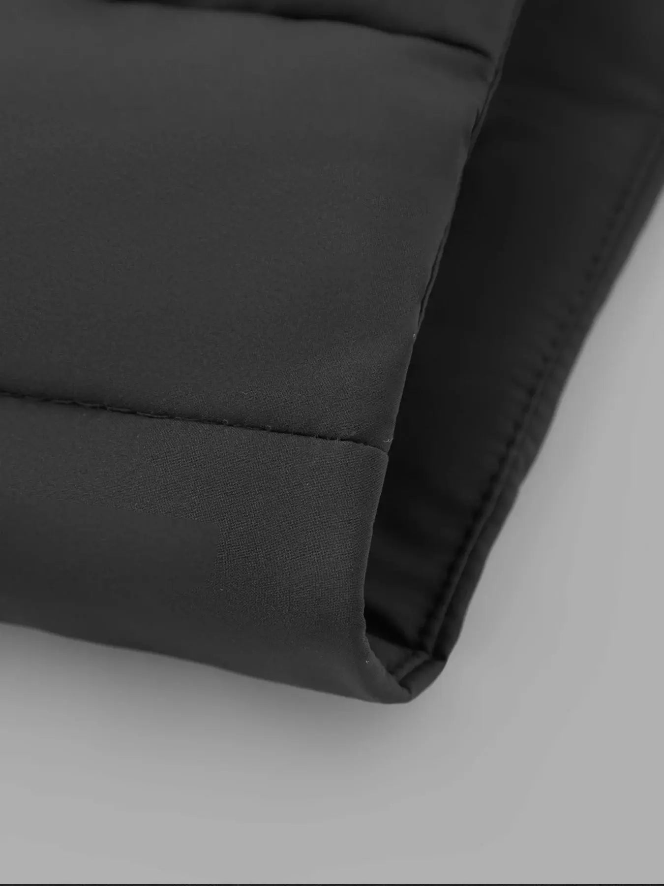 Men's black cotton jacket sleeve cuff with padded quilting detail