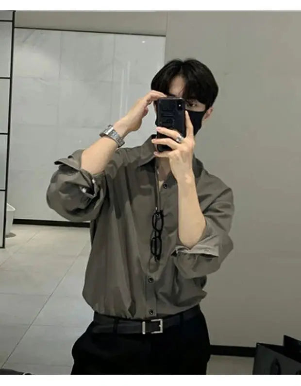 Long-sleeve gray shirt cardigan worn by man in mirror selfie, casual business look.