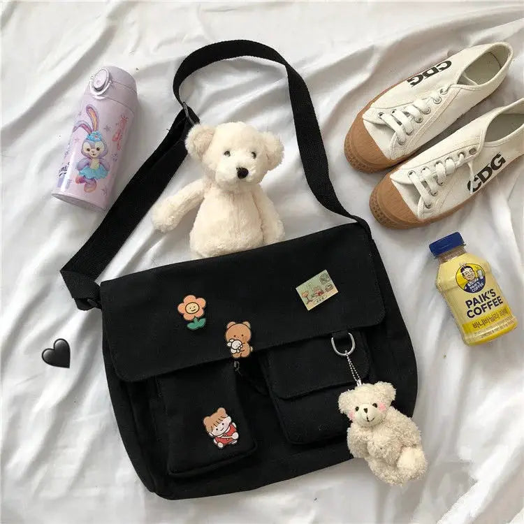 Women simple messenger bag black canvas with front flap and decorative patches, teddy bear keychain