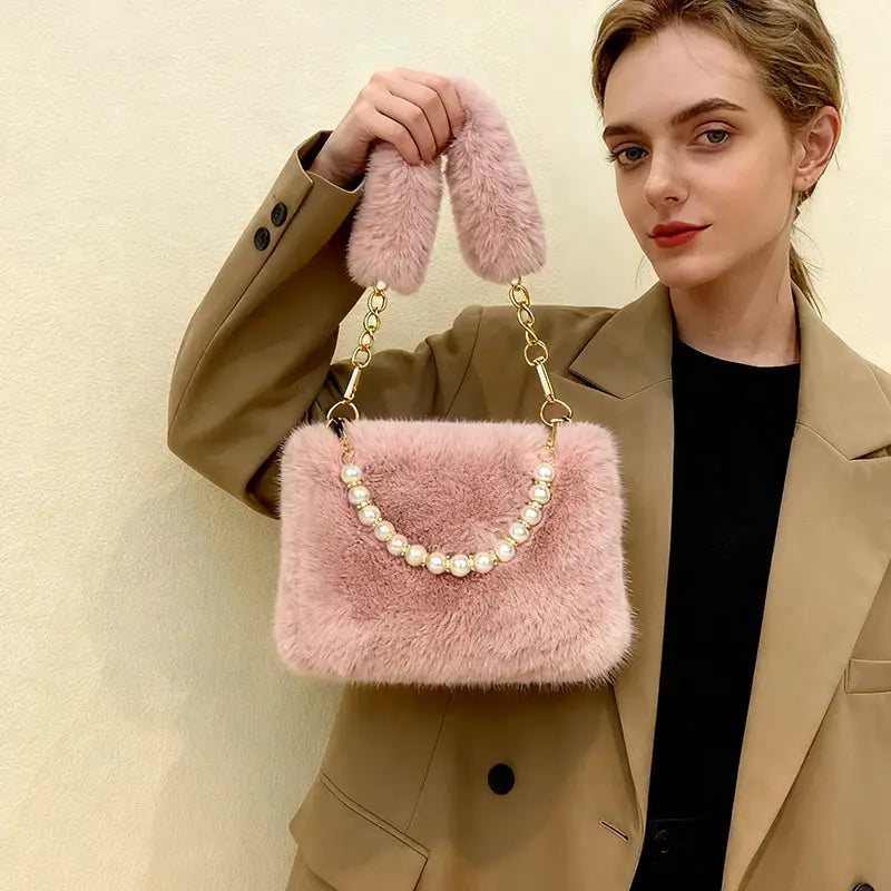 Pink rabbit fur handbag with pearl-bead chain strap and fluffy top handle.