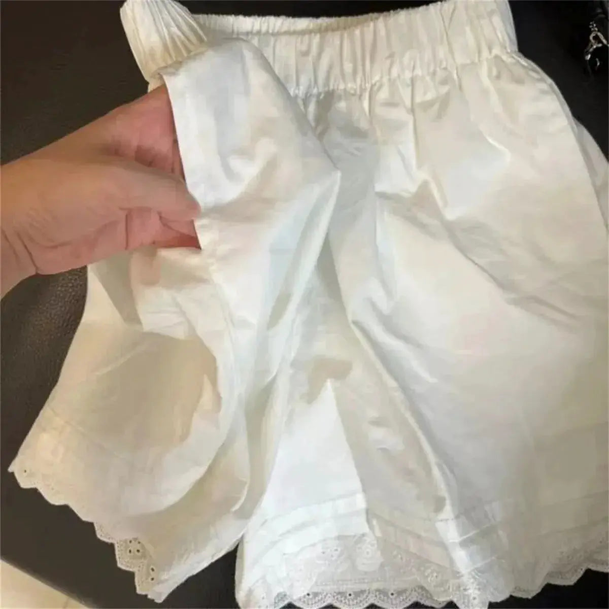 White lace-trim shorts with elastic waist, lightweight casual bottoms.