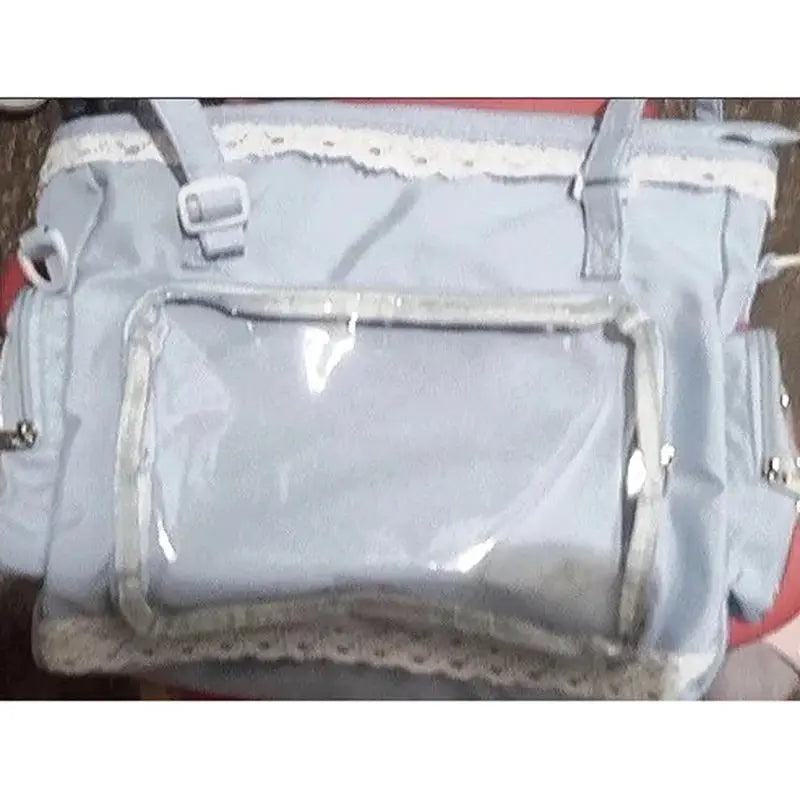 Ballet Girl Large Appetite Itabag crossbody bag in light blue with clear front pocket and lace trim; Simples Market