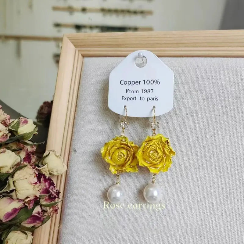 Pair of yellow rose epoxy resin long earrings with pearl drops