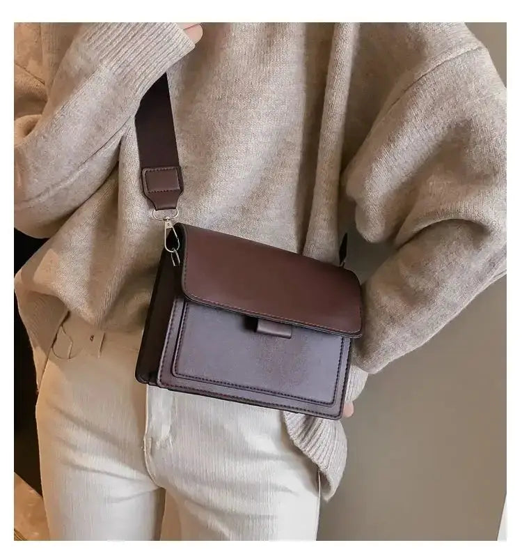 Crossbody bag in two-tone brown PU leather with front flap, compact design, and adjustable shoulder strap