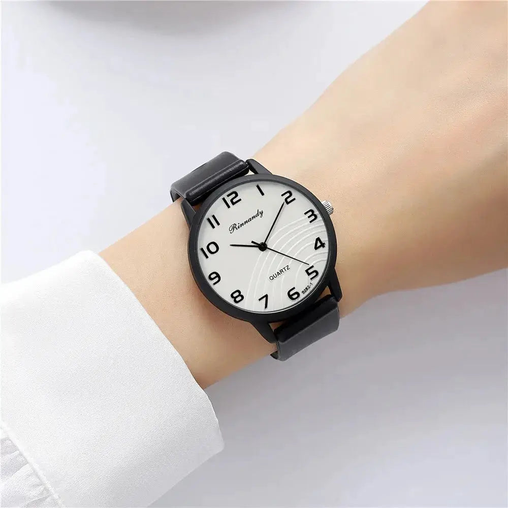 Women’s quartz wristwatch with black silicone band and white Arabic-numeral dial.