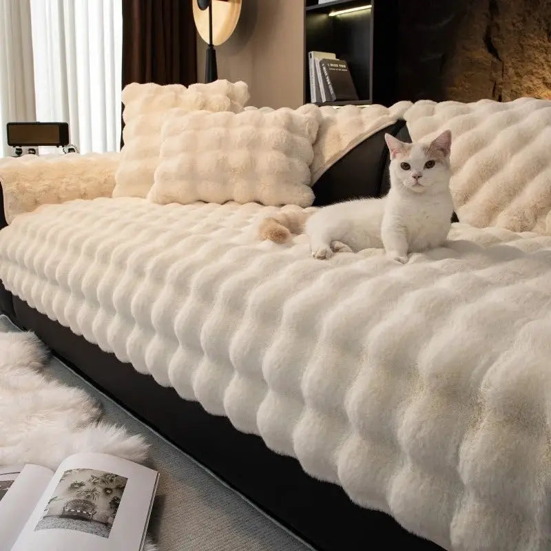 Sofa slipcover in thick ivory faux rabbit fur with non-slip backing.