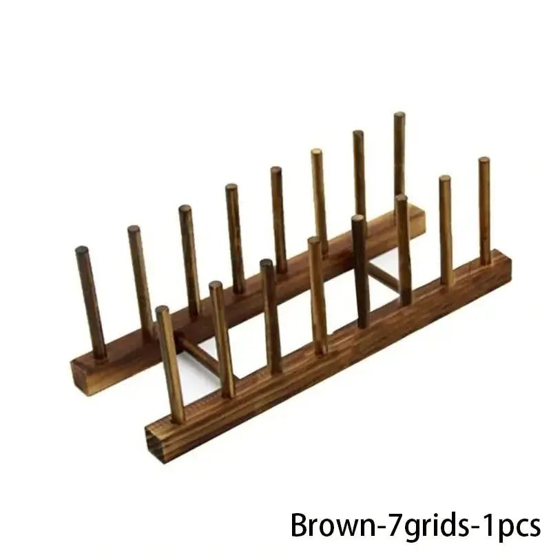 Brown wooden dish-drying rack with multiple vertical pegs for air-drying kitchenware