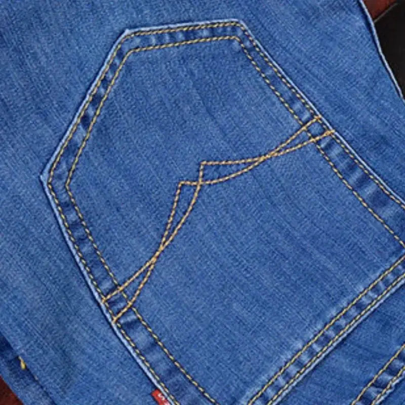 Men's Simples Market blue denim jeans with yellow stitching on back pocket, casual straight-leg style.