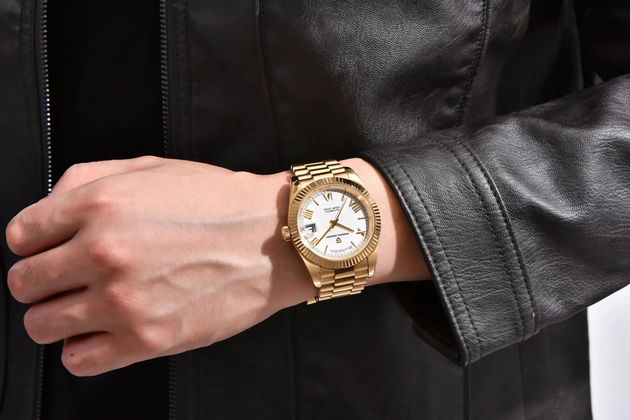 Pagani Design men's gold-tone watch with white dial and date window on a gold bracelet.