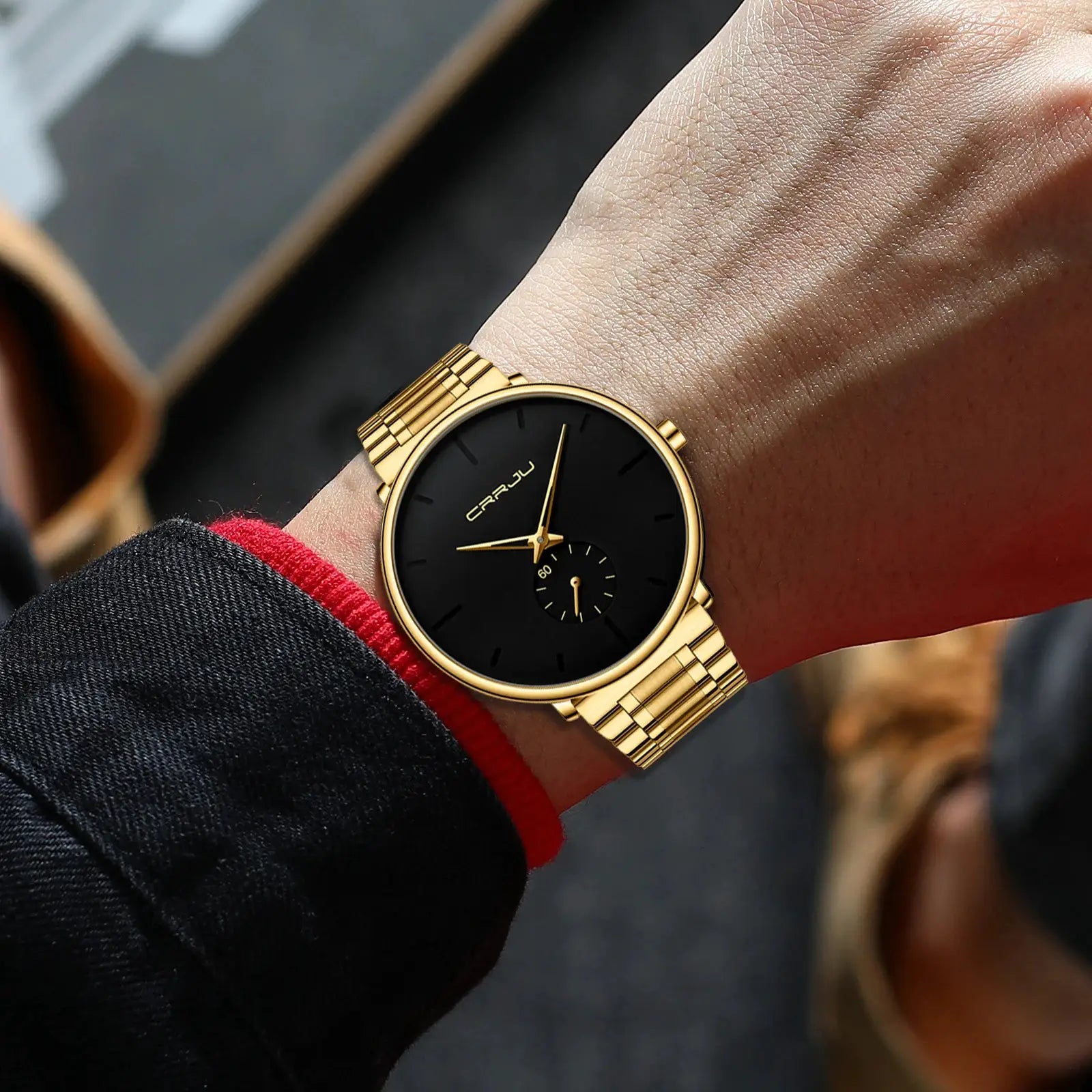 CRRJU men's gold-tone stainless steel watch with black dial on wrist