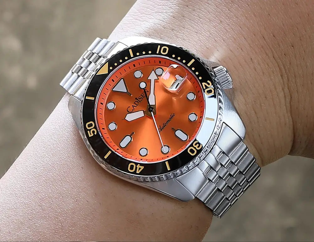CADISEN men's automatic wristwatch with orange dial, black bezel, and stainless steel bracelet