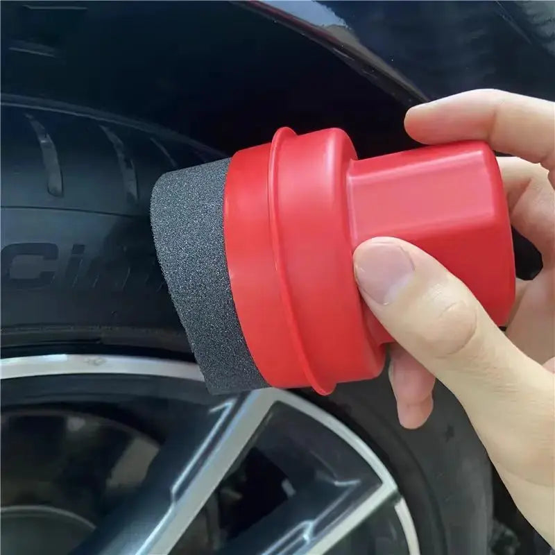 Car wheel polishing sponge brush with red curved head, foam pad, and cover for tire dressing.