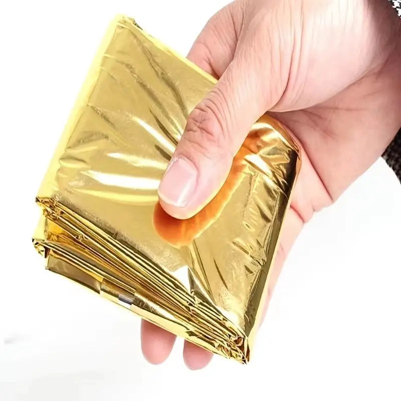 Emergency blanket, gold waterproof keep-warm blanket folded for camping and survival.