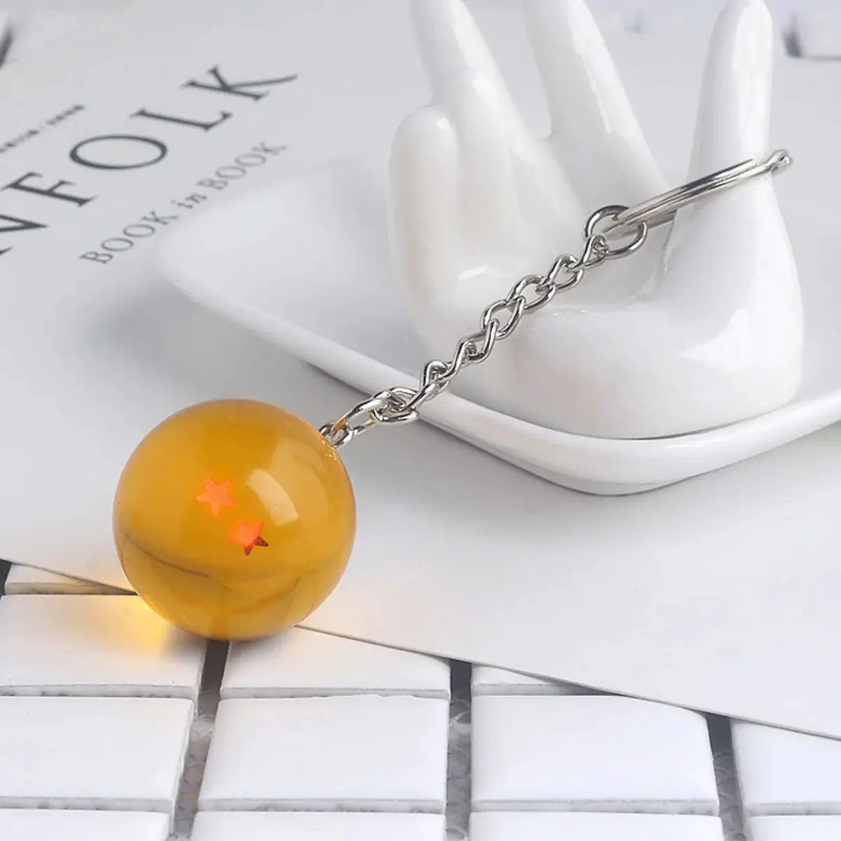 Dragon Ball keychain with orange bead and red star patterns on a silver metal chain