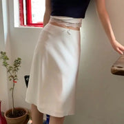 White satin A-line midi skirt with a small front bow